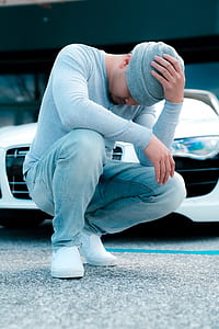 man squat beside car thumbnail