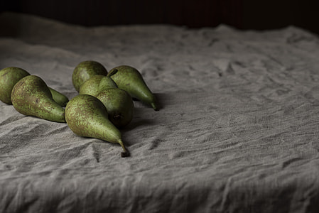 seven green oval fruits on grey textile thumbnail