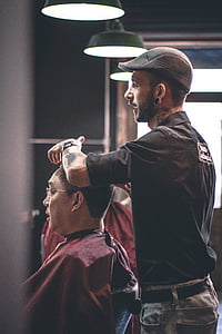 man wearing black shirt holding man's hair thumbnail