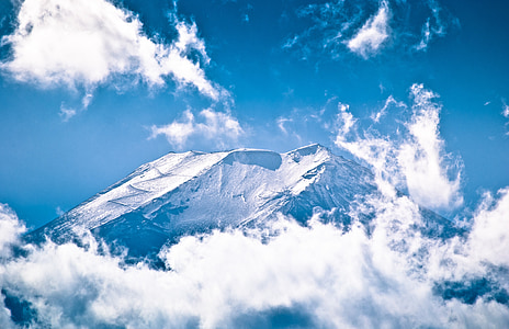snow-covered mountain surrounded by clouds thumbnail