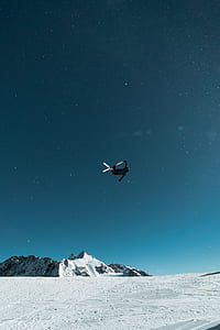 person in mid air doing tricks with ski boards thumbnail