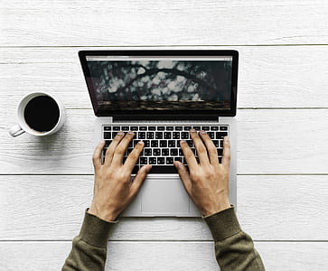 person's both hands on MacBook thumbnail