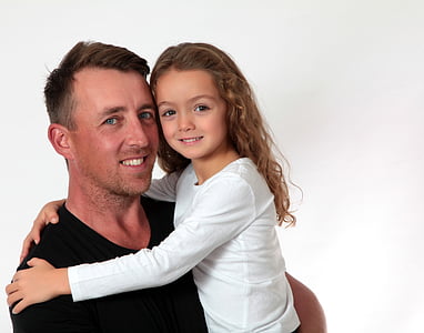 man carrying girl wearing white long-sleeved shirt thumbnail