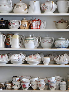 assorted-color tea set on white shelf thumbnail
