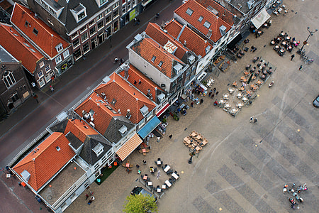 bird's-eye view photography of people and cars near houses thumbnail