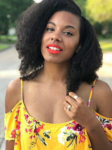 Black Haired Woman in Floral Cold-shoulder Top Smiling thumbnail