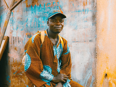 man wearing brown and blue robe and blue cap thumbnail