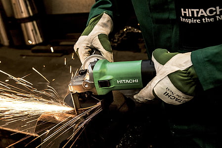 person using green Hitachi angle grinder thumbnail