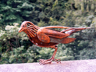 close up photography of red bird figurine thumbnail