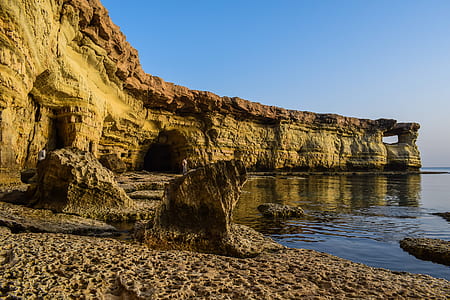 rock formations near body of water thumbnail