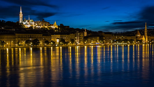 photography of city light reflecting on body of water thumbnail