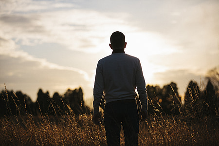 silhouette photo of man standing during golden hour thumbnail