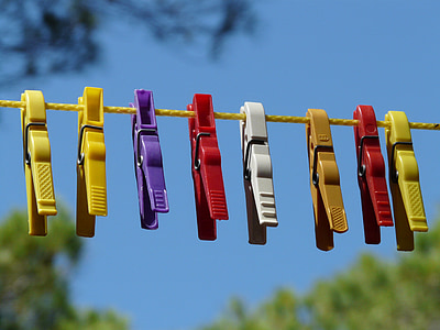 assorted-color clip hanging on yellow string thumbnail