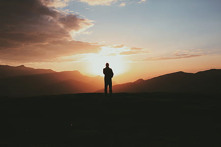 silhouette of person standing on open field thumbnail