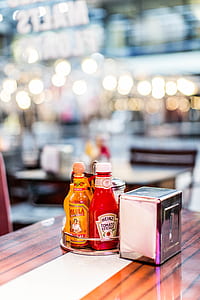gray stainless steel tissue dispenser beside Heinz tomato ketchup bottle thumbnail