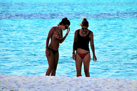 two women standing on shore thumbnail
