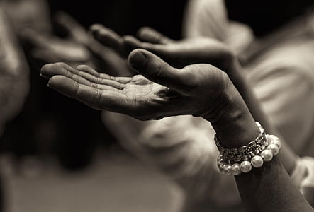 woman wearing beaded white bracelet holding her hands up high thumbnail