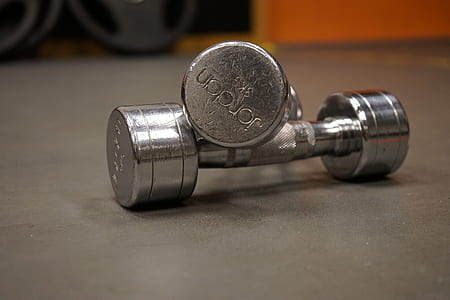 selective focus photography of two fixed weight dumbbells thumbnail