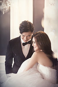 wedding couples smiling near chandelier thumbnail