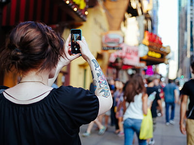 woman taking photo of building thumbnail