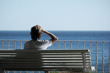 person sitting on white bench thumbnail
