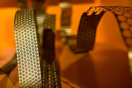 Bended golden metal on an orange background thumbnail
