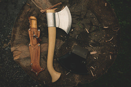 brown wooden handle throwing ax next to brown leather knife case thumbnail