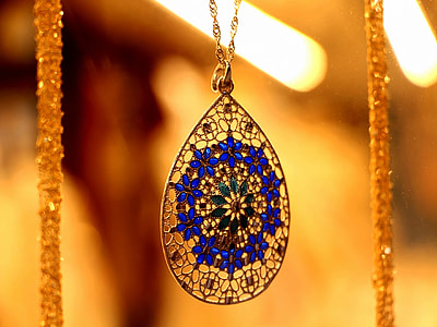 selective focus photography of teardrop pendant necklace thumbnail