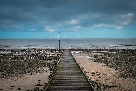 dock on seashore near body of water thumbnail