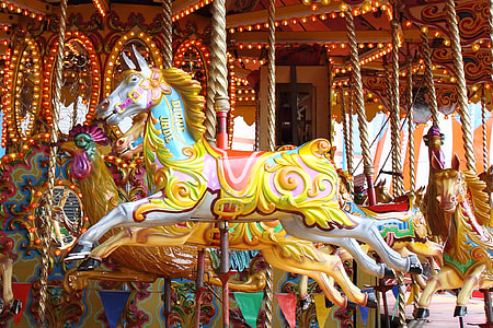 photo of white horse in carousel during day time thumbnail
