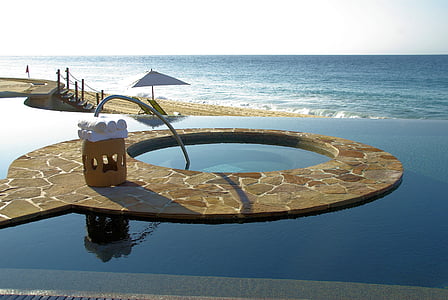 brown concrete pool frame and ocean at blue hour thumbnail