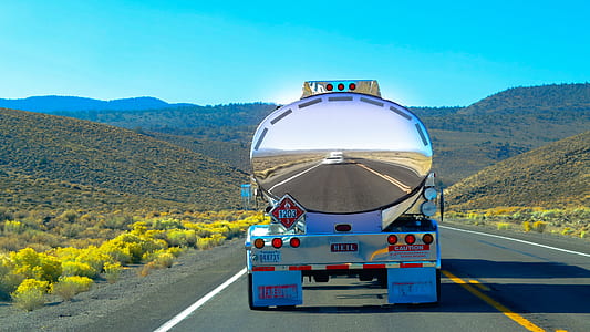 chrome-colored tanker trailer truck running on road during daytime thumbnail