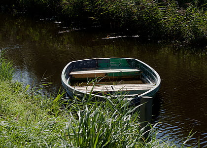 photo of green canoe on top of body of water during daytime thumbnail