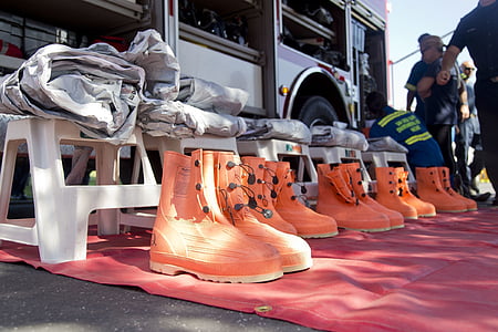 pairs of orange boots in front of stools thumbnail