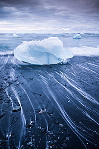 snow block on seashore under gray clouds thumbnail