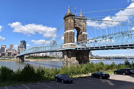 three black cars parked near bridge during daytime thumbnail