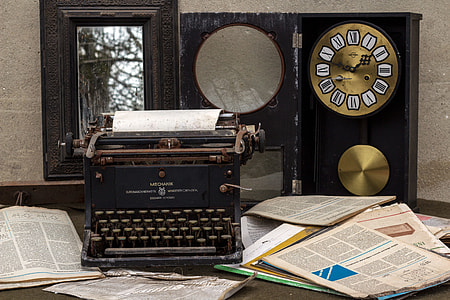 black typewriter near brown labeled papers thumbnail