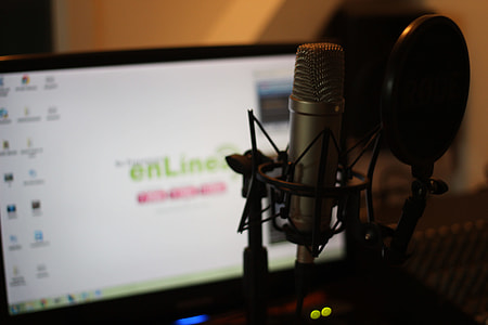 selective focus photography of gray condenser microphone with filter in front of flat screen computer monitor thumbnail