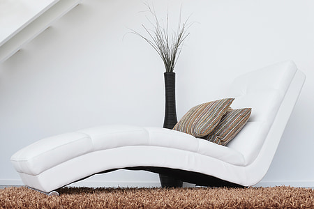 white leather lounger sofa on top of brown area rug thumbnail