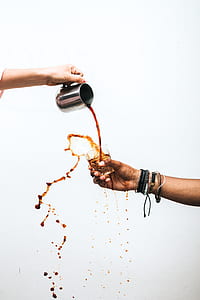 person pouring liquor in rock glass thumbnail