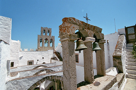 white concrete building with bells thumbnail