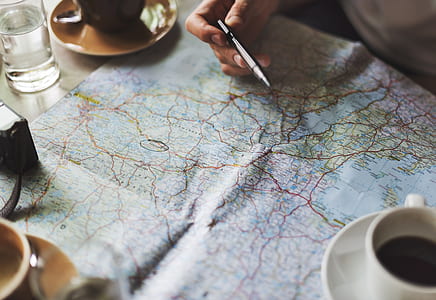white teacup filled with coffee on map illustration poster thumbnail