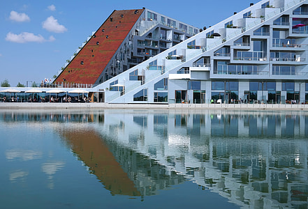 grey and brown concrete buildings near body of water during daytime thumbnail
