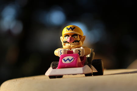 yellow toy figure on white surface thumbnail