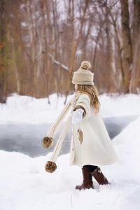girl playing outside with snow in forest thumbnail