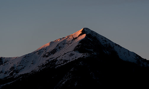 gray snowy mountain under dark sky thumbnail