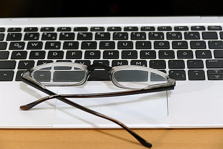 black framed eyeglasses on laptop computer thumbnail