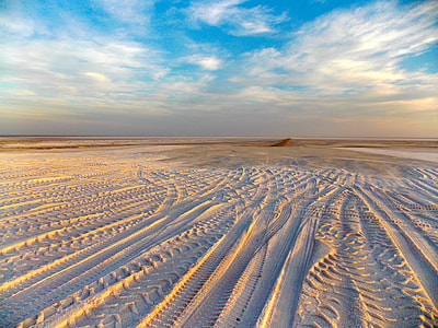 Desert Tracks under blue sky and clouds thumbnail