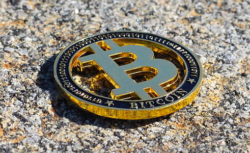 gold Bitcoin on gray concrete floor thumbnail