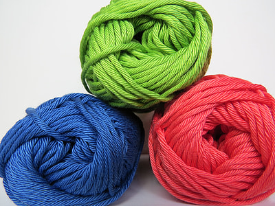 three green, red, and blue yarn rolls with white background thumbnail
